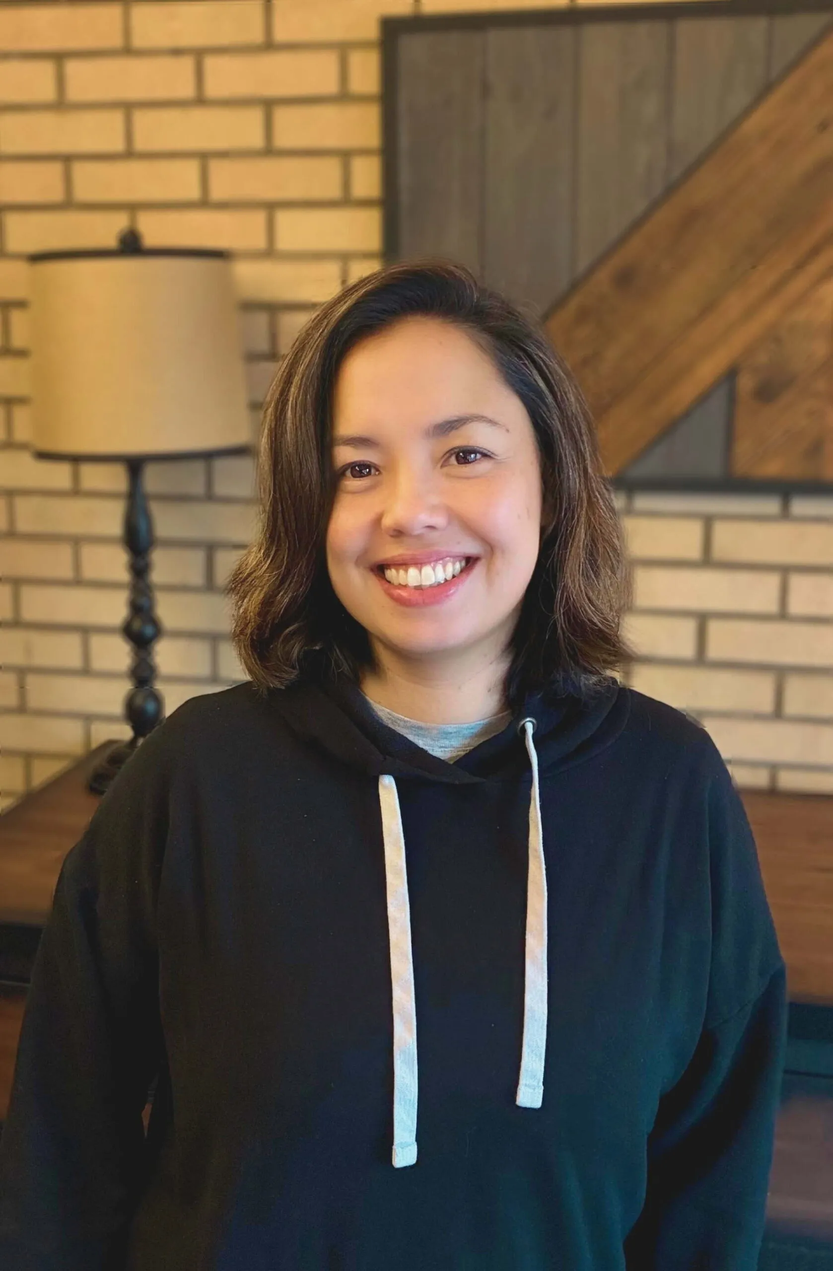 : A professional portrait of Mayumi, a dedicated team member at One Heart Warriors working to restore Native communities through education and mentorship.
